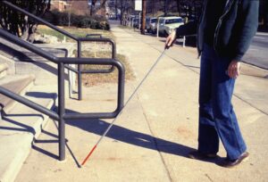 Image of a blind person using a cane