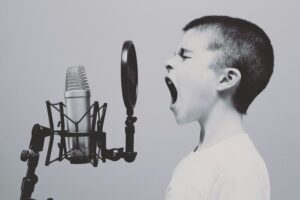 Image of child making sound into microphone