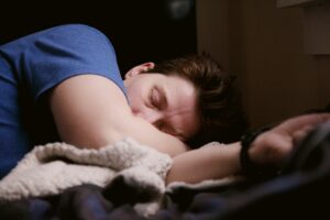 Image of a man looking unwell and sleeping