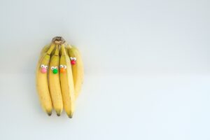 Image of a bunch of bananas with cartoon faces